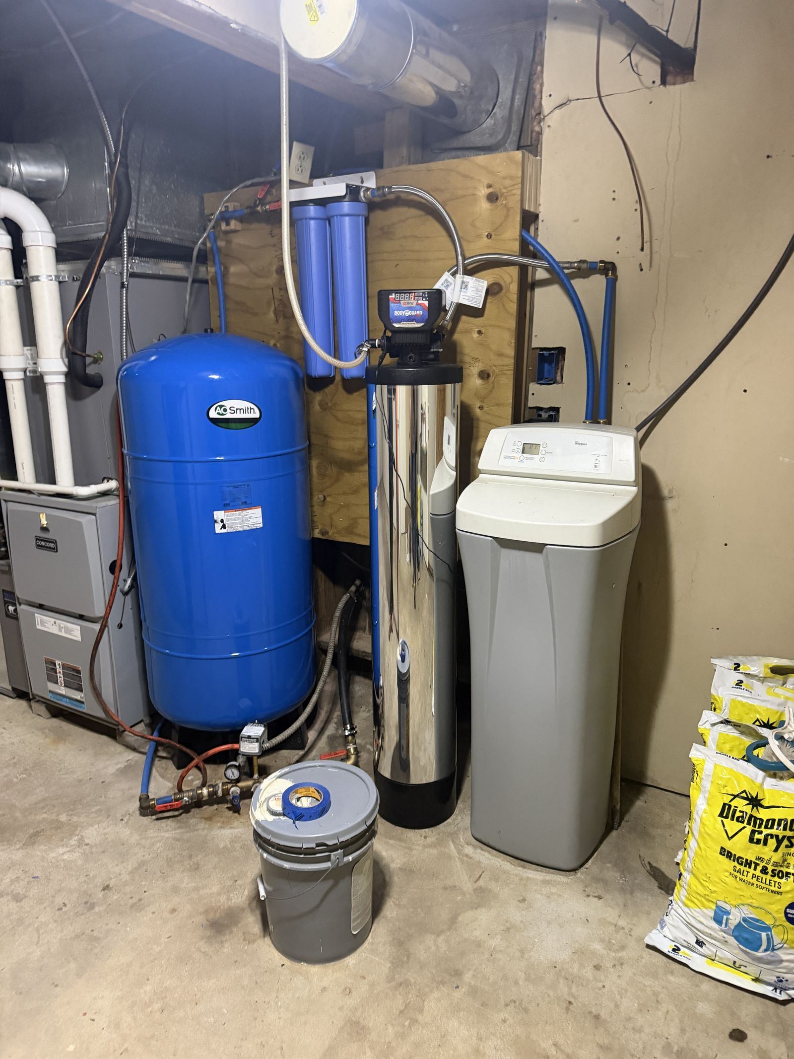 Before: push-fitting plumbing, cartridge filters and a big-box water softener in an Ortonville, MI basement